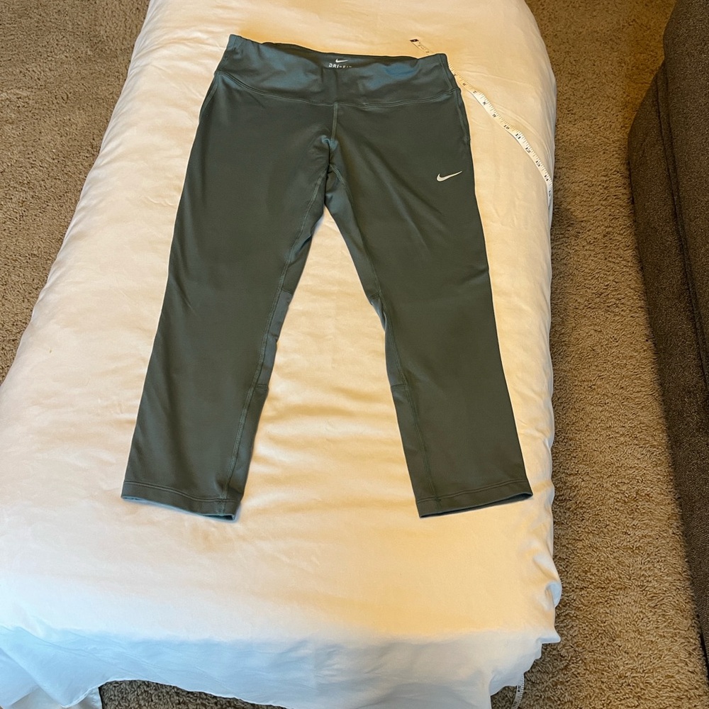 Nike Dri fit Comfortable olive green leggings with iconic Nike swoosh.